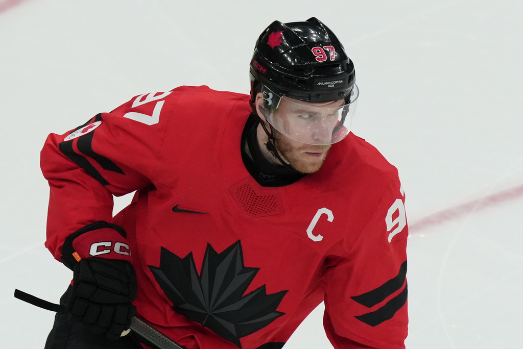Canada's Connor McDavid wears the team captain's letter C on his jersey in place of the injured Sidney Crosby during the second period of a men's ice hockey semifinal game against Finland at the 2026 Winter Olympics in Milan, Italy, Friday, Feb. 20, 2026. (AP Photo/Carolyn Kaster)
