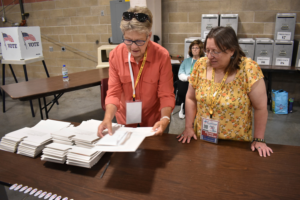 FILE - Election workers Janet Lambert, left, and Renee Tucker are seen sorting ballots at the MetraPark events center, Tuesday, June 4, 2024, in Billings, Mont. (AP Photo/Matthew Brown,File)