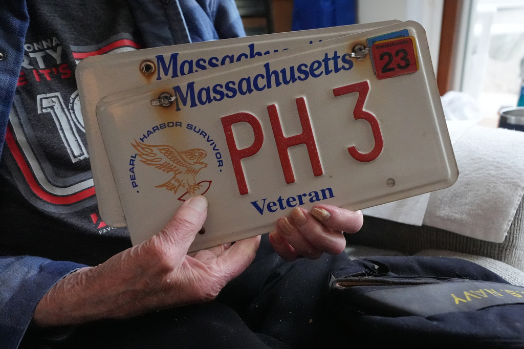 Freeman K. Johnson, a 106-year-old Pearl Harbor survivor, holds his veteran license plate during an interview at his home, May 6, 2026, in Centerville, Mass. (AP Photo/Charles Krupa)