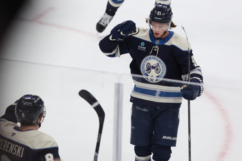 Columbus Blue Jackets forward Kent Johnson, right, celebrates his overtime goal against the New York Rangers with teammate defenseman Zach Werenski during an NHL hockey game in Columbus, Ohio, Saturday, Oct. 17, 2026. (AP Photo/Paul Vernon)
