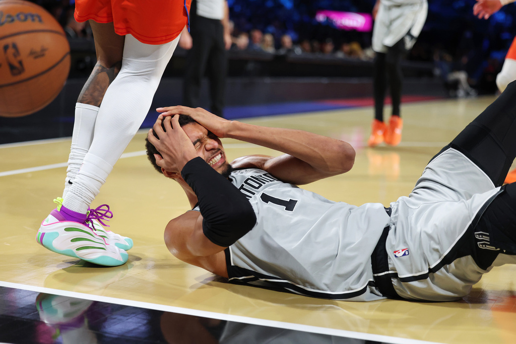 San Antonio Spurs forward Victor Wembanyama (1) lands on the court during the second half of an NBA Cup semifinals basketball game against the Oklahoma City Thunder, Saturday, Dec. 13, 2025, in Las Vegas. (AP Photo/Ronda Churchill)