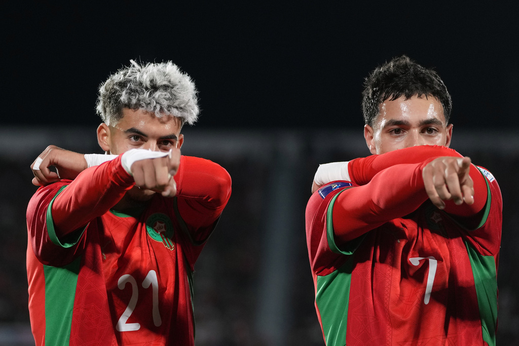 Morocco's Yassir Zabiri, left, celebrates with teammates Othmane Maamma after scoring his side's second goal against Argentina during the FIFA U-20 World Cup final soccer match in Santiago, Chile, Sunday, Oct. 19, 2025.(AP Photo/Andre Penner)