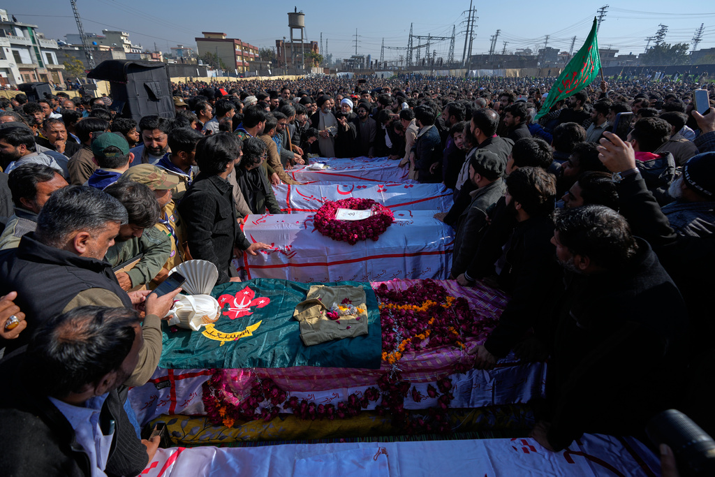 Mourners arrange the coffins of the victims of Friday's suicide bombing inside a Shiite mosque, during a funeral prayer, in Islamabad, Pakistan, Saturday, Feb. 7, 2026. (AP Photo/Anjum Naveed)