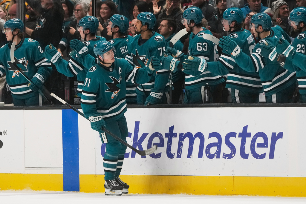 San Jose Sharks center Macklin Celebrini (71) is congratulated by teammates after scoring against the Boston Bruins during the second period of an NHL hockey game in San Jose, Calif., Sunday, Nov. 23, 2025. (AP Photo/Jeff Chiu)