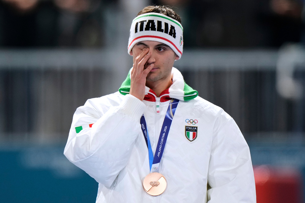 Riccardo Lorello of Italy reacts after winning the bronze medal on the men's 5,000 meters speedskating race at the 2026 Winter Olympics, in Milan, Italy, Sunday, Feb. 8, 2026. (AP Photo/Luca Bruno)