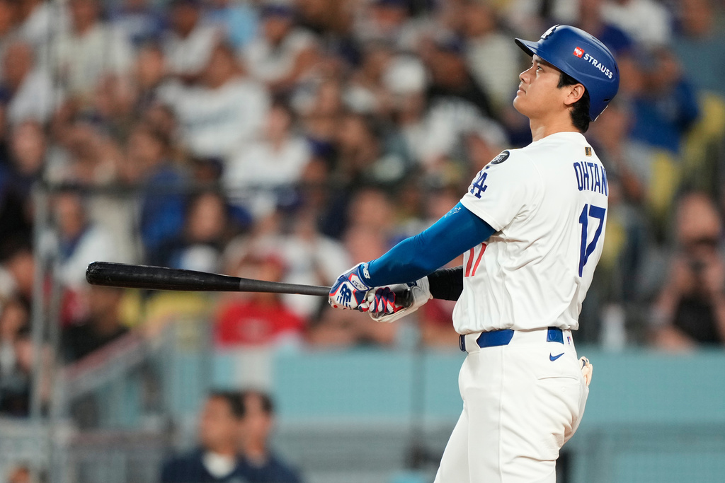 Los Angeles Dodgers' Shohei Ohtani follows through on his two-run home run during the sixth inning in Game 1 of the National League Wild Card baseball playoff series against the Cincinnati Reds, Tuesday, Sept. 30, 2025, in Los Angeles. (AP Photo/Mark J. Terrill)