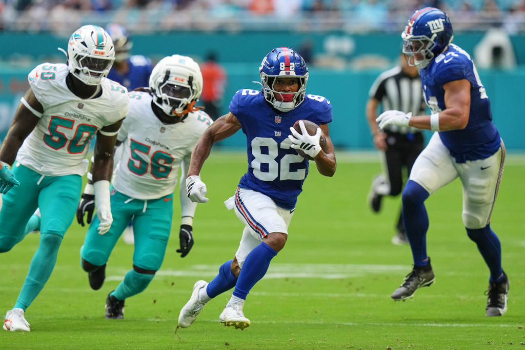 New York Giants wide receiver Calvin Austin III (82) runs the ball during the first half of a preseason NFL football game against the Miami Dolphins, Saturday, Aug. 22, 2026, in Miami Gardens, Fla. (AP Photo/Lynne Sladky)
