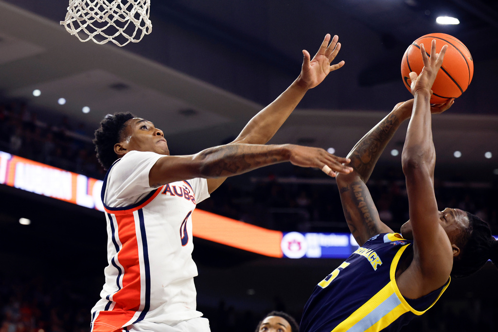 Merrimack guard Kevair Kennedy, right, is fouled by Auburn guard Tahaad Pettiford, left, as he shoots during the first half of an NCAA college basketball game, Thursday, Nov. 6, 2025, in Auburn, Ala. (AP Photo/Butch Dill)