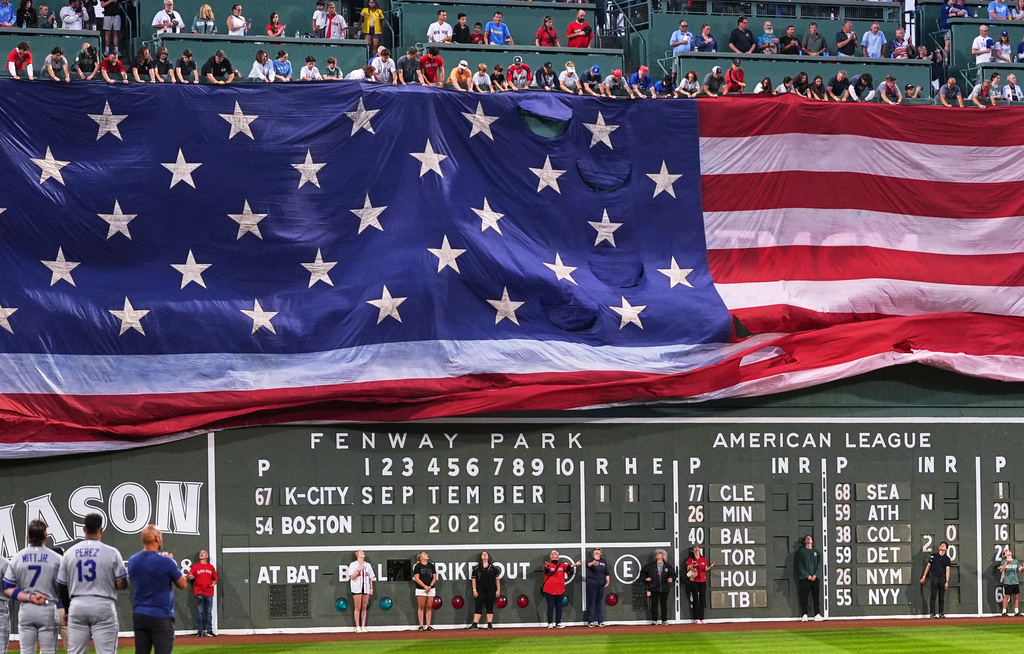 A giant flag is unfurled honoring the victims of Sept. 11th attacks prior to a baseball game between the Boston Red Sox and Kansas City Royals, Friday, Sept. 11, 2026, in Boston. (AP Photo/Charles Krupa)