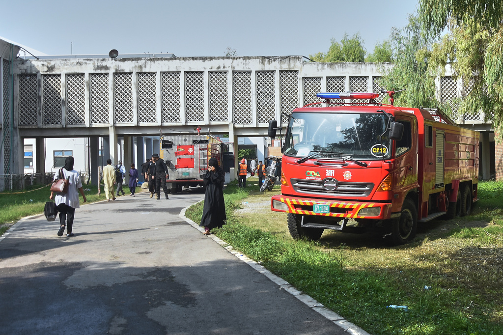 Firefighter trucks park outside a nursery in the gynecology ward following a fire at a hospital, in Islamabad, Pakistan, Wednesday, Aug. 26, 2026. (AP Photo)