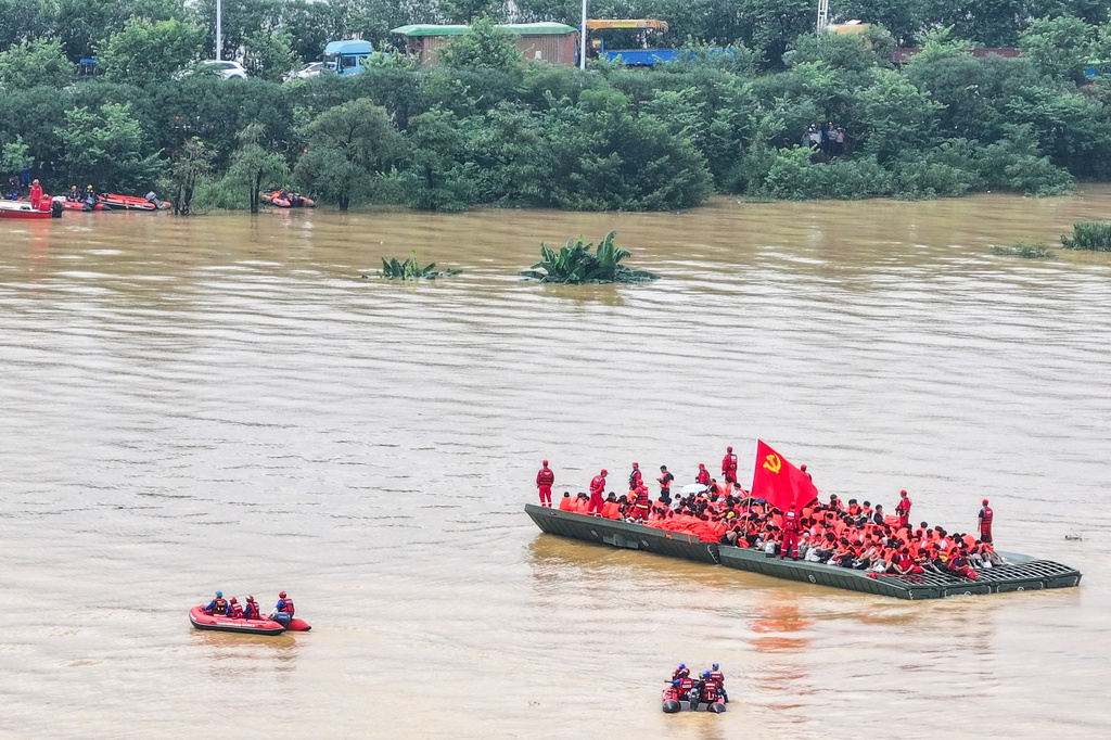 In this drone photo released by Xinhua News Agency, rescuers evacuated students trapped in the aftermath of tropical storm Maysak in Guigang City, southern China's Guangxi Zhuang Autonomous Region, Thursday July 9, 2026. (Cao Yiming/Xinhua via AP)