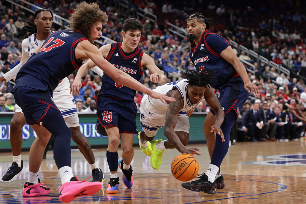 Seton Hall guard Trey Parker falls to the floor in front of St. John's forward Rubén Prey (17) during the second half of an NCAA college basketball game Friday, March 6, 2026, in Newark, N.J. (AP Photo/Adam Hunger)