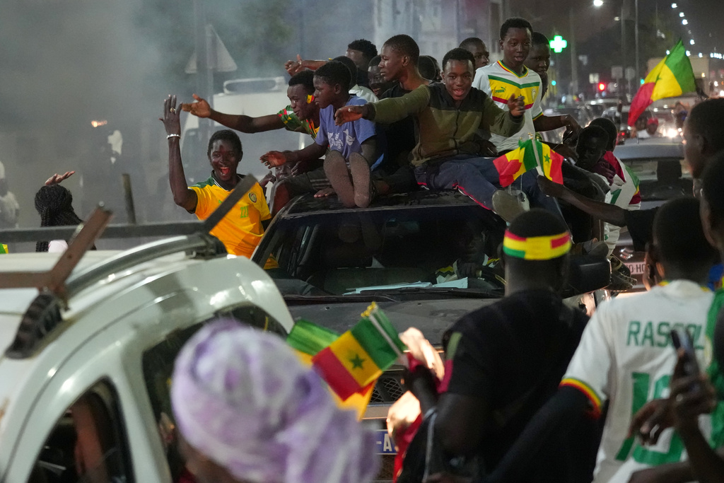 Fans celebrate Senegal's victory semifinal soccer match over Egypt, guaranteeing them a spot in the final of the Africa Cup of Nations (AFCON) 2025 tournament, in Dakar, Senegal, Wednesday, Jan. 14, 2026. (AP Photo/Misper Apawu)