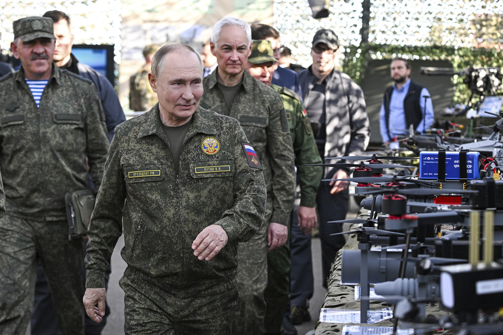 CORRECTS SOURCE FOR POOL - Russian President Vladimir Putin accompanied by Deputy Defence Minister Yunus-Bek Yevkurov, left, and Defence Minister Andrei Belousov, right, inspects Russian weapons and equipment during his visit to the Russian-Belarusian joint military drills "Zapad 2025" (West 2025) at the Mulino training ground in Nizhny Novgorod region, Russia, Tuesday, Sept. 16, 2025. (Sergey Bobylev/Sputnik, Kremlin Pool Photo via AP)