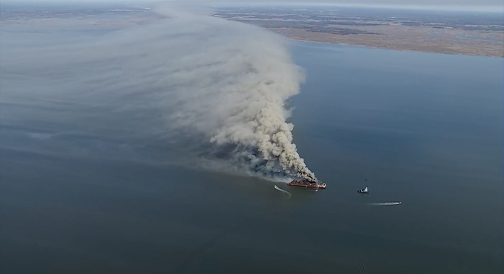 Smoke fills the sky as firefighters battle a massive blaze that erupted on a barge on the Delaware River on Tuesday, March 10, 2026 in New Castle, Del. (WPVI via AP)