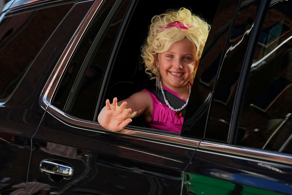 Maria Vantrease waves from a car as she wears a Dolly Parton costume Friday, Sept. 25, 2026, in Nashville, Tenn. during Dolly Parton Day honoring the late country music artist. (AP Photo/George Walker IV)