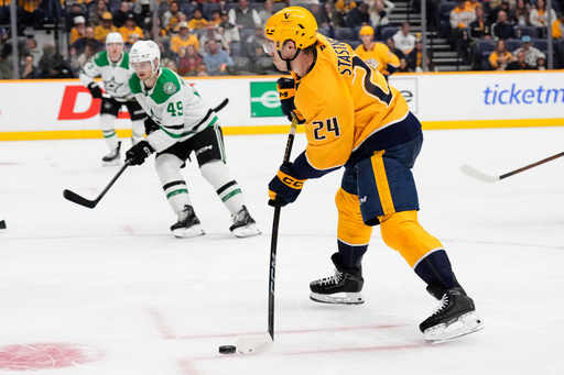Nashville Predators defenseman Spencer Stastney (24) shoots to the puck to scores goal during the second period of an NHL hockey game against the Dallas Stars, Sunday, Oct. 26, 2025, in Nashville, Tenn. (AP Photo/George Walker IV) Nashville Predators defenseman Spencer Stastney (24) shoots to the puck to scores goal during the second period of an NHL hockey game against the Dallas Stars, Sunday, Oct. 26, 2025, in Nashville, Tenn. (AP Photo/George Walker IV)