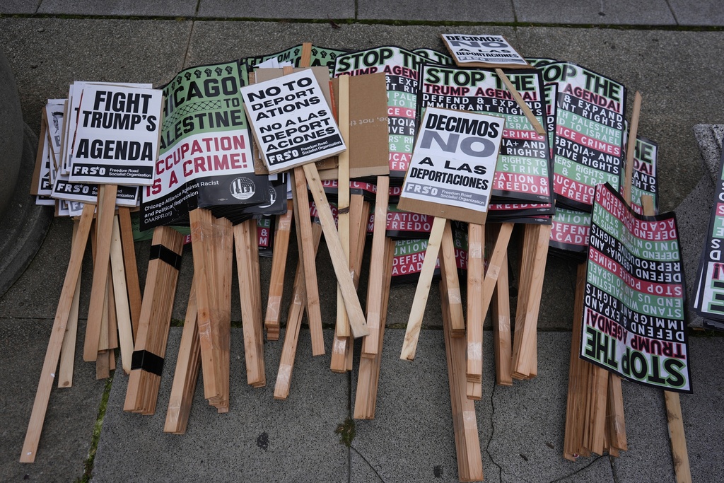 Signs are seen as people prepare for Illinois Coalition for Immigrant & Refugee Rights' "Chicago Says No Trump No Troops" protest Saturday, Sept. 6, 2025, in Chicago. (AP Photo/Carolyn Kaster)