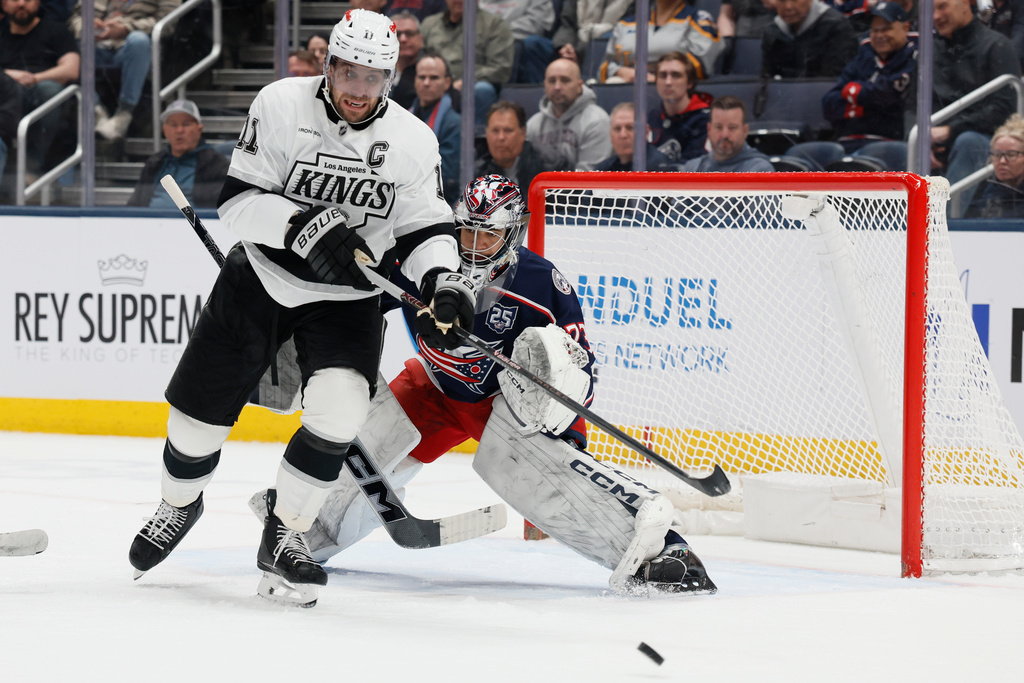 Columbus Blue Jackets' Jet Greaves, right, deflects the puck away from Los Angeles Kings' Anze Kopitar during the second period of an NHL hockey game, Monday, March 9, 2026, in Columbus, Ohio. (AP Photo/Jay LaPrete)