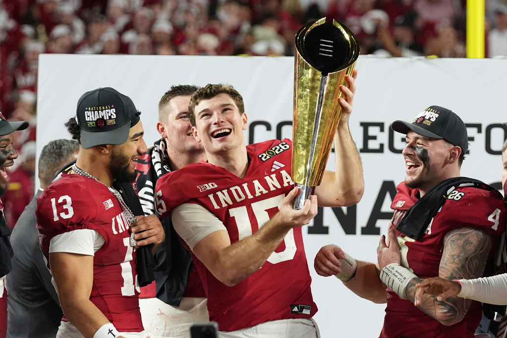 FILE - Indiana quarterback Fernando Mendoza (15) holds the trophy after Indiana defeated Miami in a College Football Playoff national championship game, Monday, Jan. 19, 2026, in Miami Gardens, Fla. (AP Photo/Lynne Sladky, File)