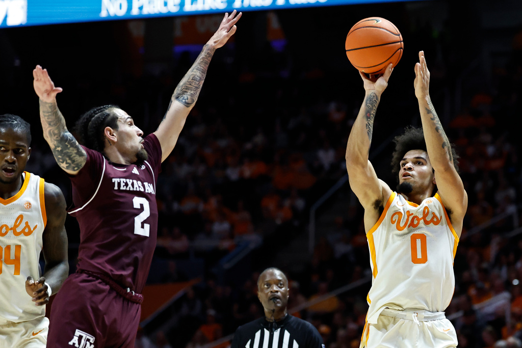 Tennessee guard Ja'kobi Gillespie (0) shoots over Texas A&M guard Pop Isaacs (2) during the first half of an NCAA college basketball game Tuesday, Jan. 13, 2026, in Knoxville, Tenn. (AP Photo/Wade Payne)