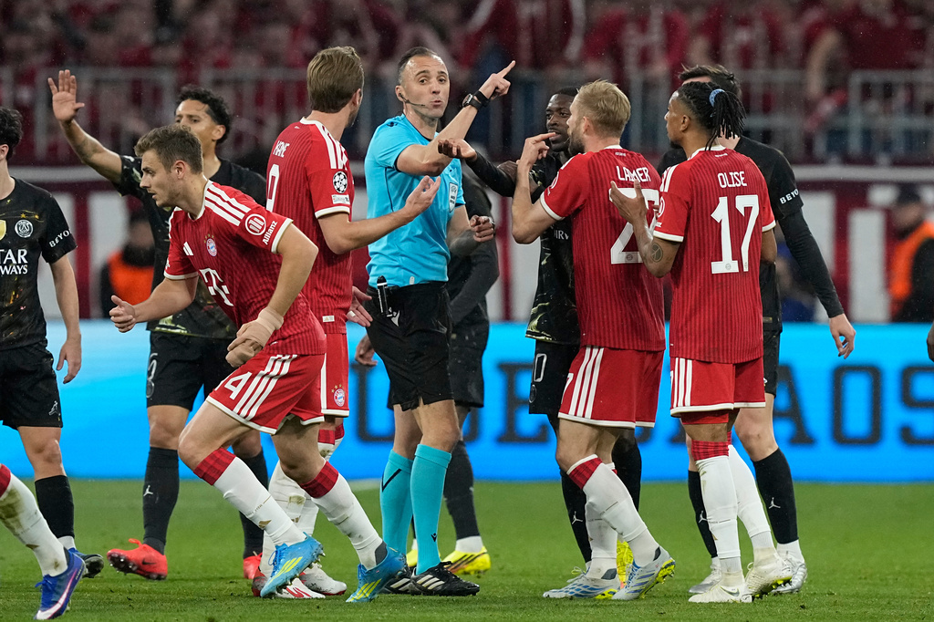 Bayern players react after referee Joao Pinheiro's decision during the Champions League semifinal second leg soccer match between Bayern Munich and Paris Saint Germain in Munich, Germany, Wednesday, May 6, 2026. (AP Photo/Martin Meissner)