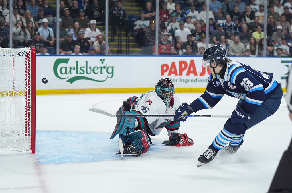 Chicoutimi Sagueneens' Liam Lefebvre (39) scores against Kelowna Rockets goalie Josh Banini (35) during the first period of a Memorial Cup hockey game in Kelowna, British Columbia, Sunday, May 24, 2026. (Darryl Dyck/The Canadian Press via AP)