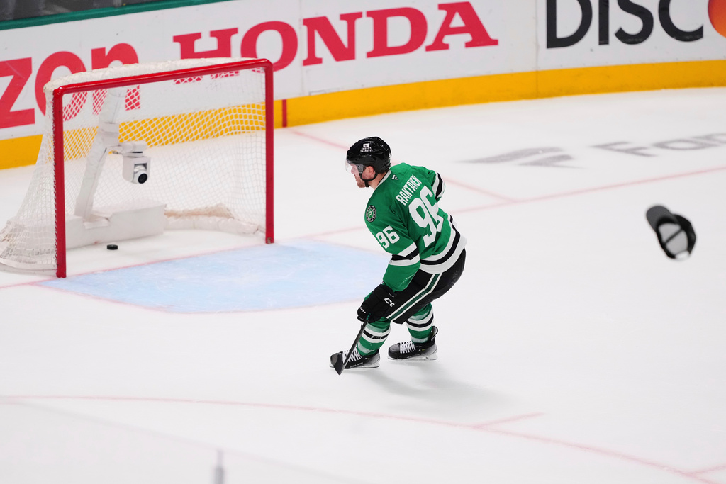 FILE - A hat is thrown onto the ice as Dallas Stars' Mikko Rantanen (96) scores an empty-net goal against to earn a hat trick in the third period in Game 7 of a first-round NHL hockey playoff series againts the Colorado Avalanche Saturday, May 3, 2025, in Dallas. (AP Photo/Julio Cortez, file)