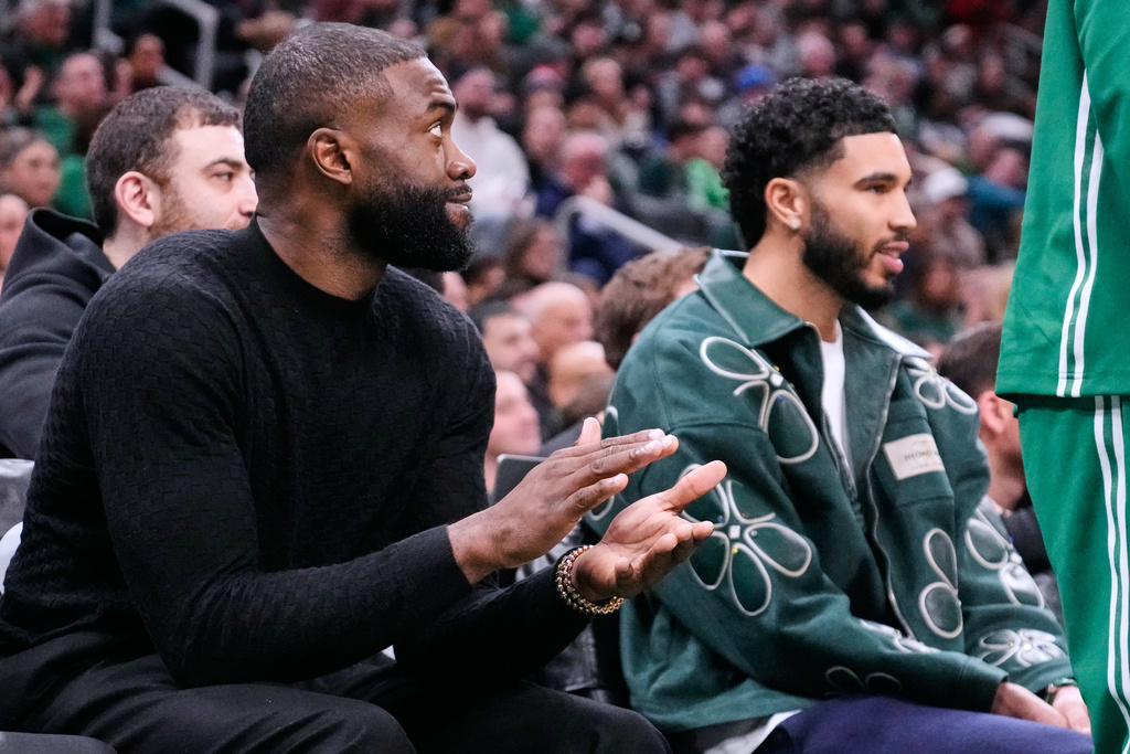 Boston Celtics guard Jaylen Brown, left, applauds while seated alongside forward Jayson Tatum, who both did not play, during the first half of an NBA basketball game against the Sacramento Kings, Friday, Jan. 30, 2026, in Boston. (AP Photo/Charles Krupa)