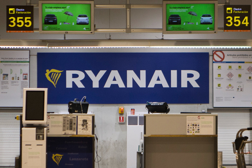 FILE - The Ryanair desk is seen, Aug. 10, 2018, at the Barajas airport in Madrid, Spain. (AP Photo/Paul White, File)