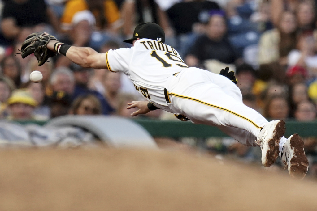 Pittsburgh Pirates third baseman Jared Triolo reaches for but cannot field a double hit by Cincinnati Reds' Noelvi Marte during the fourth inning of a baseball game, Saturday, Aug. 9, 2025, in Pittsburgh. (AP Photo/Matt Freed)