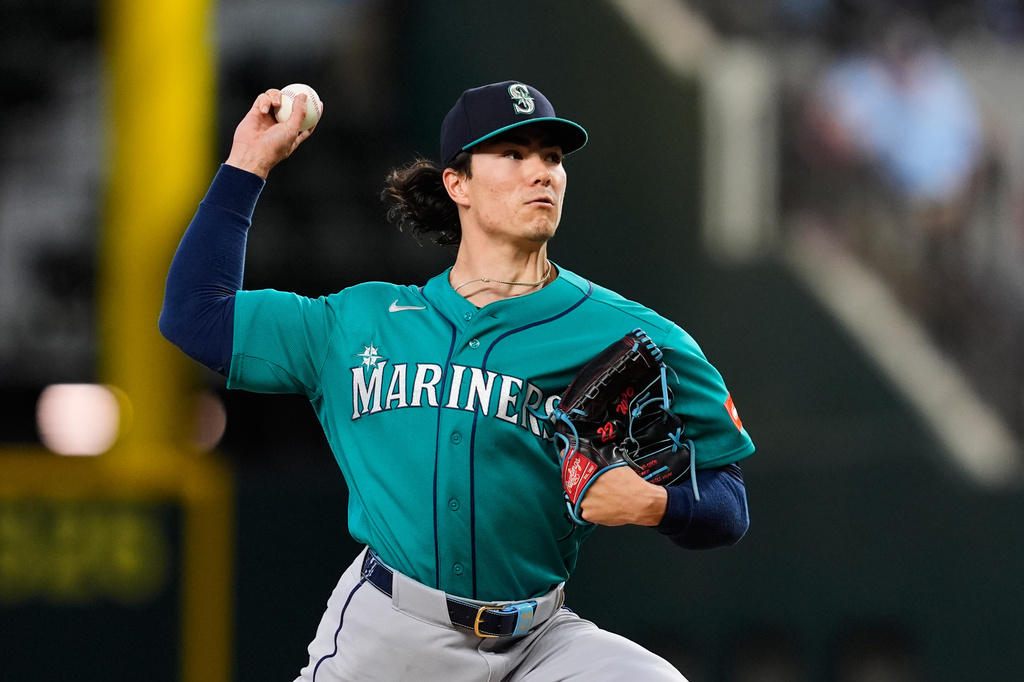 Seattle Mariners pitcher Bryan Woo throws to the Texas Rangers in the first inning of a baseball game Wednesday, April 8, 2026, in Arlington, Texas. (AP Photo/Tony Gutierrez)