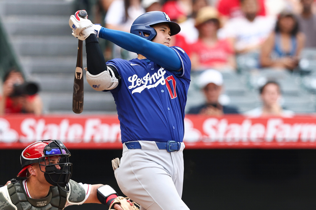 Los Angeles Dodgers' Shohei Ohtani follows through on an RBI single during the fourth inning of a baseball game against the Los Angeles Angels, Sunday, May 17, 2026, in Anaheim, Calif. (AP Photo/Jessie Alcheh)