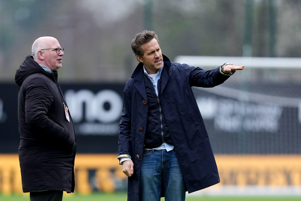 Wrexham co-owner Ryan Reynolds, right, with Wrexham Director Shaun Harvey on the pitch ahead of the English FA Cup fifth round soccer match between at Wrexham and Chelsea in Wrexham, Wales, Saturday March 7, 2026. (Martin Rickett/PA via AP)