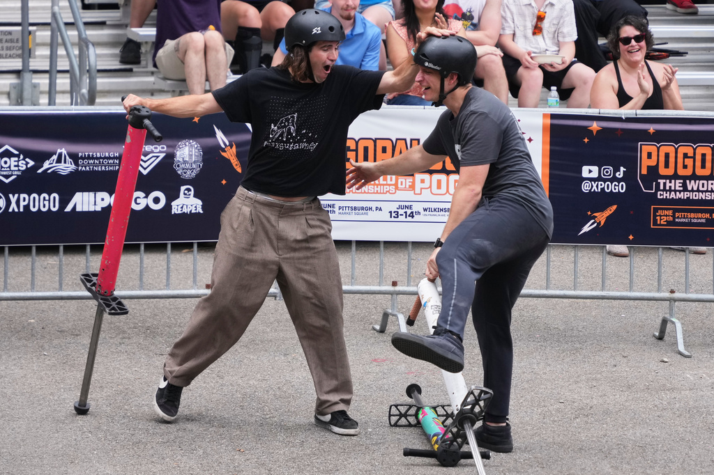Pogo athlete Michael Mena, right, celebrates with Henry Cabelus after his award winning trick during the Best Trick competition of Pogopalooza 2026 in Wilkinsburg, Pa., Sunday, June 14, 2026. (AP Photo/Gene J. Puskar)