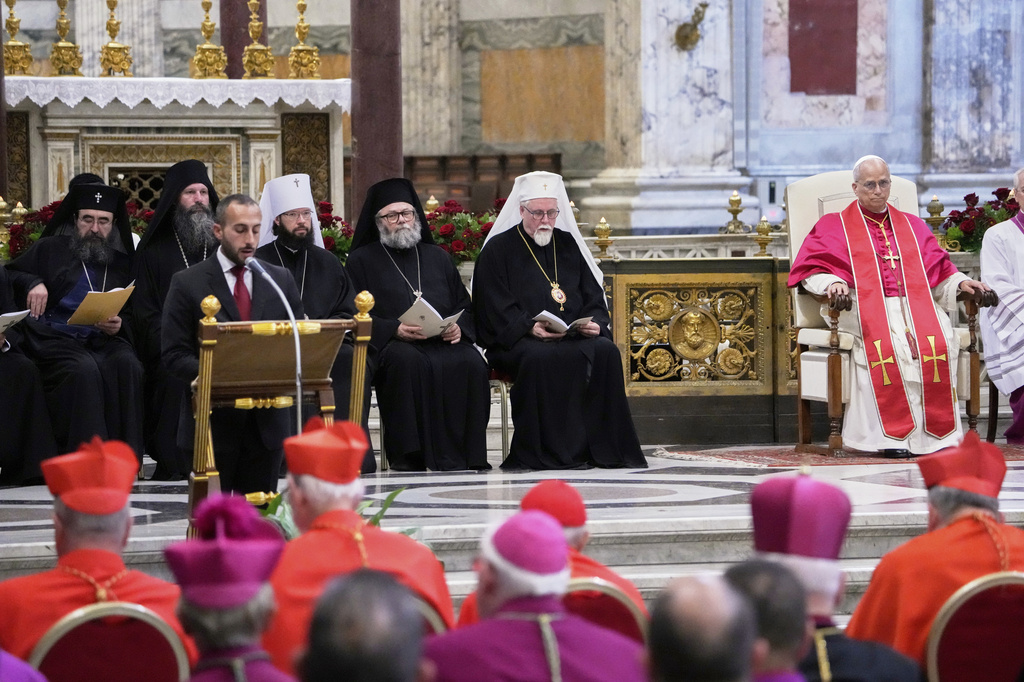 Pope Leo XIV, right, presides over a commemoration of the martyrs and witnesses of the faith of the 21st century with representatives of other churches and Christian communions in the Basilica of St. Paul Outside the Walls in Rome, Sunday, Sept. 14, 2025. (AP Photo/Gregorio Borgia)