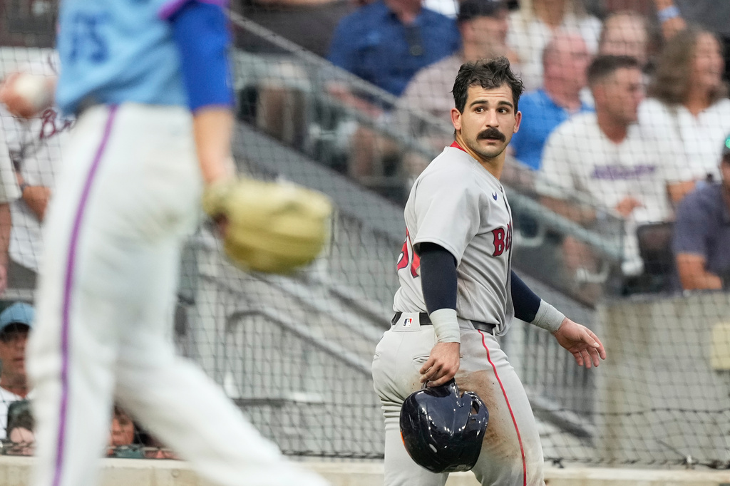 Boston Red Sox Mickey Gasper (30) looks back after he slides safely into home against Atlanta Braves catcher Sandy León in the fourth inning of a baseball game Saturday, May 16, 2026, in Atlanta. (AP Photo/Brynn Anderson)