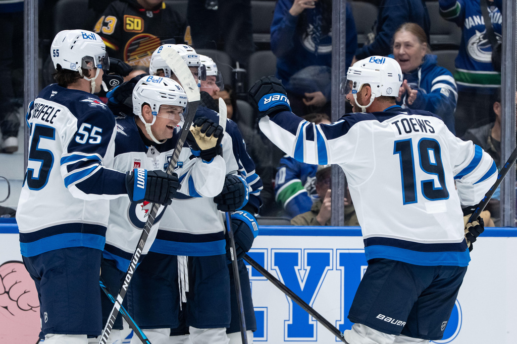 Winnipeg Jets' Cole Perfetti (91) celebrates his winning goal against the Vancouver Canucks during an overtime NHL hockey game in Vancouver, B.C., on Wednesday, Feb. 25, 2026. (Ethan Cairns/The Canadian Press via AP)