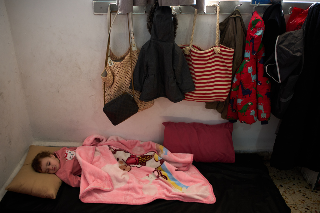 Malika Rabaa, 1, who fled with her family following Israeli strikes in southern Lebanon, sleeps in a school used as a shelter in Beirut, Lebanon, Wednesday, March 25, 2026. (AP Photo/Emilio Morenatti)