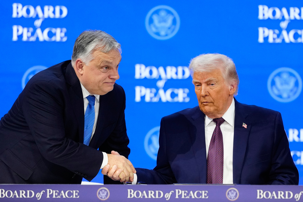FILE - President Donald Trump shakes hands with Prime Minister of Hungary Viktor Orban, left, during a signing ceremony on his Board of Peace initiative at the Annual Meeting of the World Economic Forum in Davos, Switzerland, Thursday, Jan. 22, 2026. (AP Photo/Markus Schreiber, File)