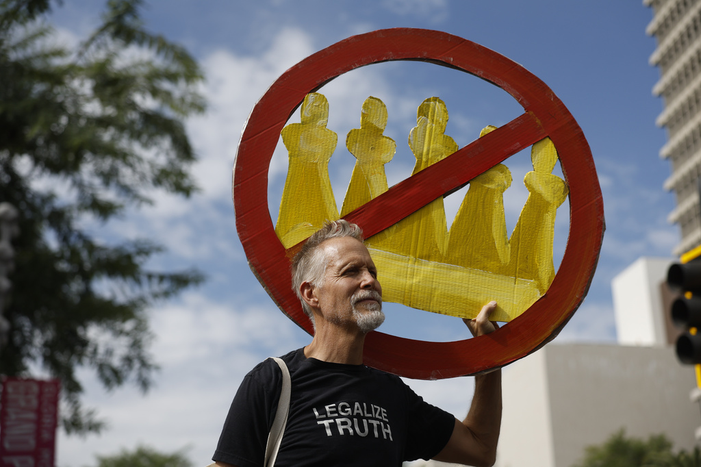 A demonstrator holds a "No Kings" sign during a protest in Los Angeles on Saturday, Oct. 17, 2026. (AP Photo/Caroline Brehman)