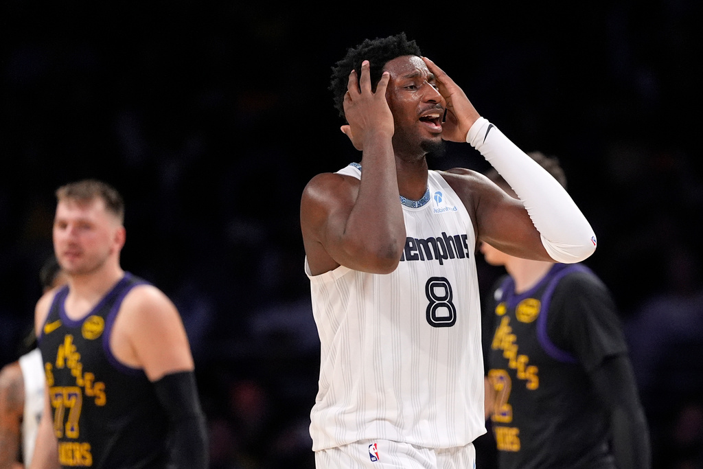 Memphis Grizzlies forward Jaren Jackson Jr., right, reacts after being called for a foul on Los Angeles Lakers guard Luka Doncic, left, during the first half of an NBA basketball game Friday, Jan. 2, 2026, in Los Angeles. (AP Photo/Mark J. Terrill)