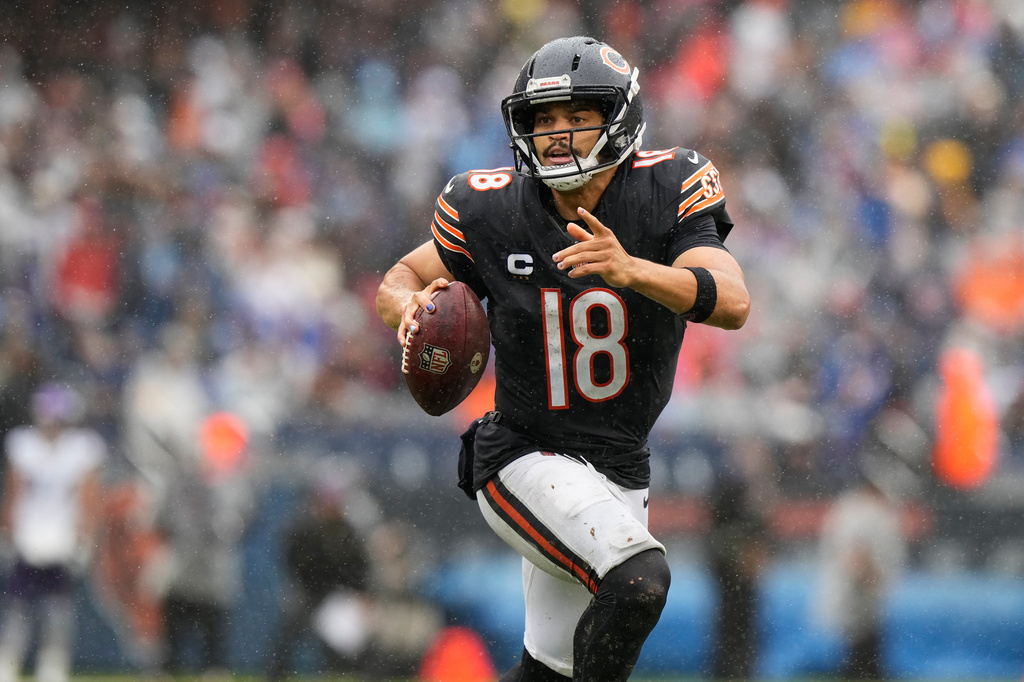 Chicago Bears quarterback Caleb Williams (18) runs with the football during the second half of an NFL football game against the Minnesota Vikings in Chicago, Sunday, Sept. 20, 2026. (AP Photo/Nam Y. Huh)