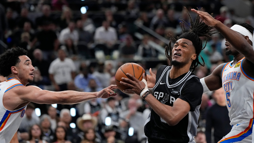 San Antonio Spurs guard Stephon Castle (5) drives past Oklahoma City Thunder guard Luguentz Dort (5) in the second half of Game 6 in the Western Conference finals NBA basketball playoffs series, Thursday, May 28, 2026, in San Antonio. (AP Photo/David J. Phillip)