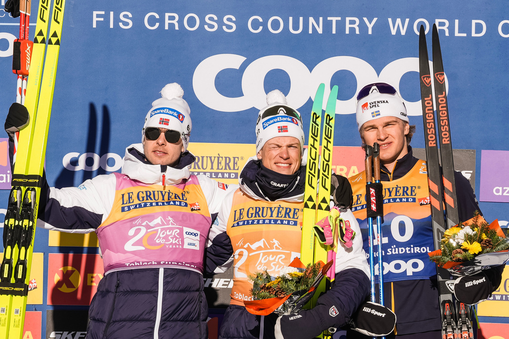 Norway's Johannes Høsflot Klæbo, center, winner of the men's 20 km pursuit classic, part of the Tour de ski, cross-country skiing event, is flanked by second placed Mattis Stenshagen, left, and third placed Sweden's Edvin Anger in Dobbiaco, Italy, Thursday, Jan. 1, 2026. (Terje Pedersen/NTB Scanpix via AP)
