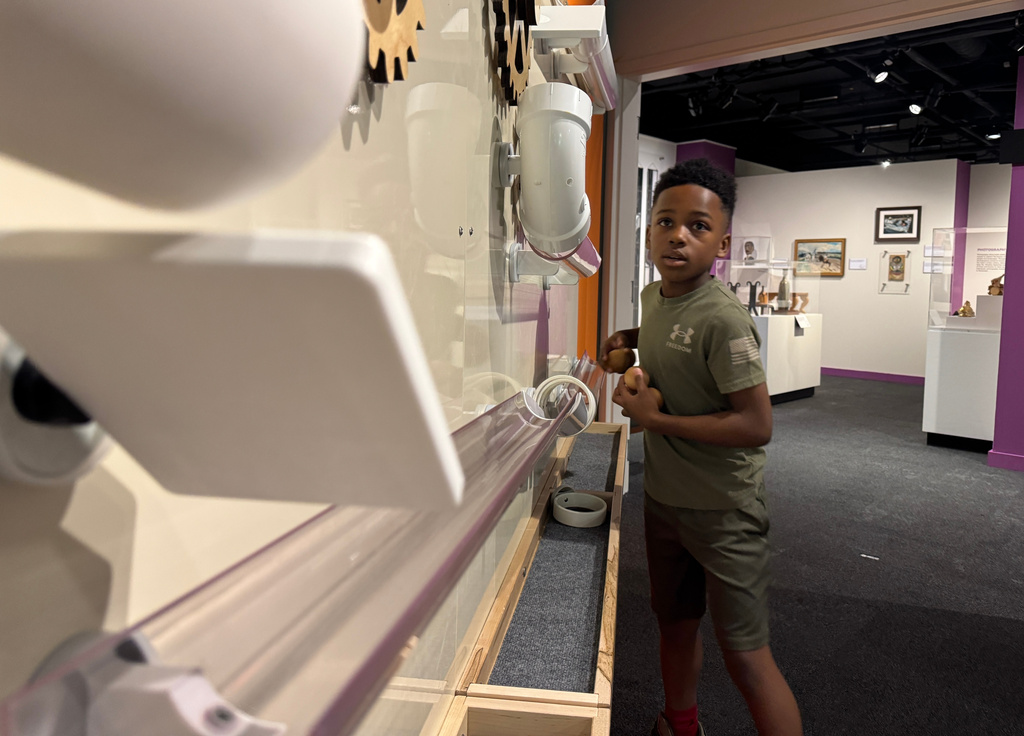 Jackson Strong, 9, plays with an interactive section of the Mississippi Made exhibit on Friday, March 27, 2026, in Jackson, Miss. (AP Photo/Sophie Bates)