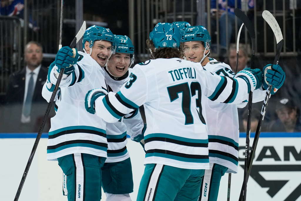 San Jose Sharks' Macklin Celebrini, second from left, celebrates his goal with teammates during the first period of an NHL hockey game against the New York Rangers in New York, Thursday, Oct. 23, 2025. (AP Photo/Seth Wenig)