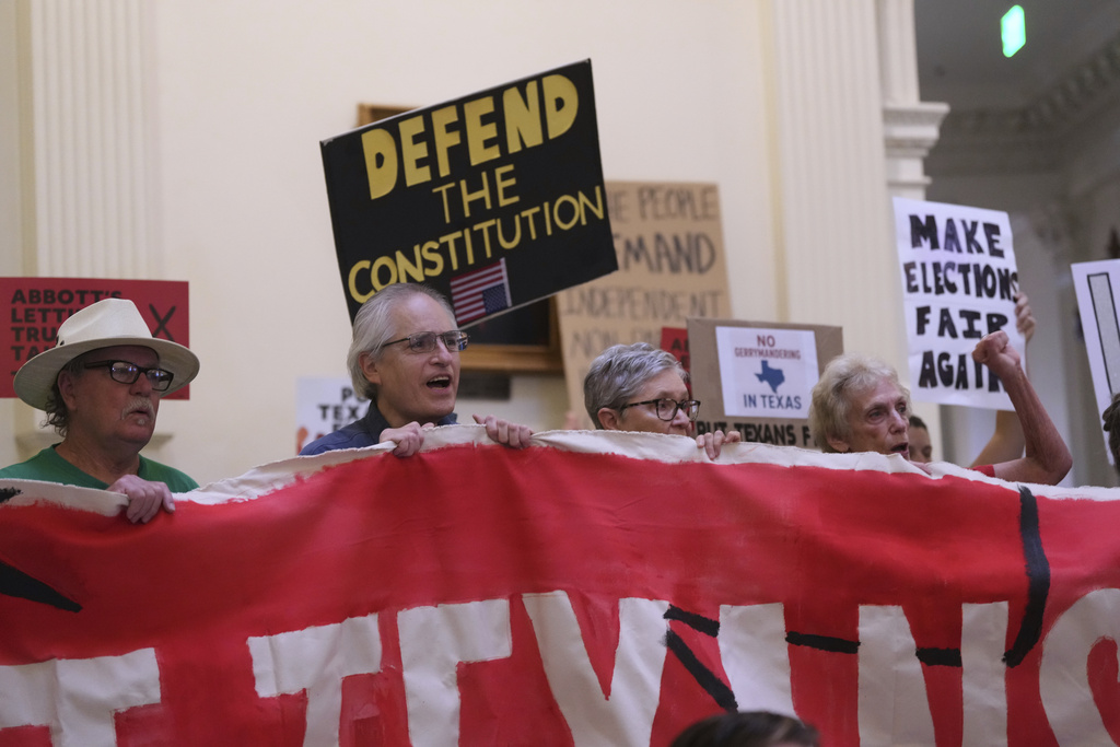 Protesters gather in the rotunda outside the House Chamber at the Texas Capitol as lawmakers debate a redrawn U.S. congressional map in Texas during a special session, Wednesday, Aug. 20, 2025, in Austin, Texas. (AP Photo/Eric Gay)