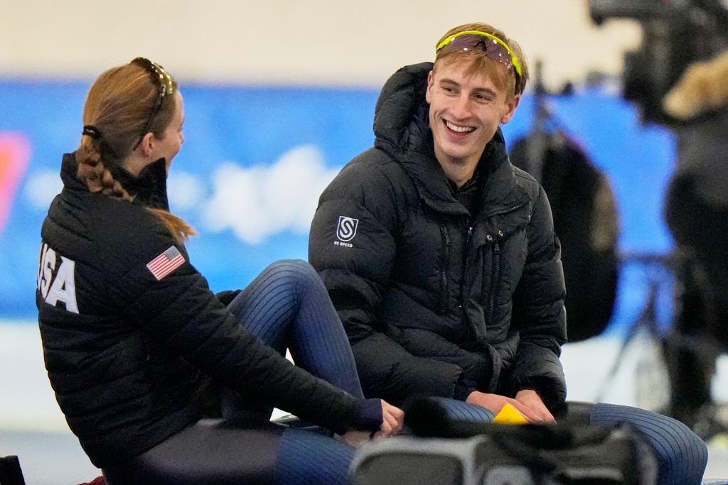 Speedskater Jordan Stolz talks to speedskater Rebecca Simmons at the U.S. Olympic trials for long track speed skating at the Pettit National Ice Center Sunday, Jan. 4, 2026 in Milwaukee. (AP Photo/Morry Gash)