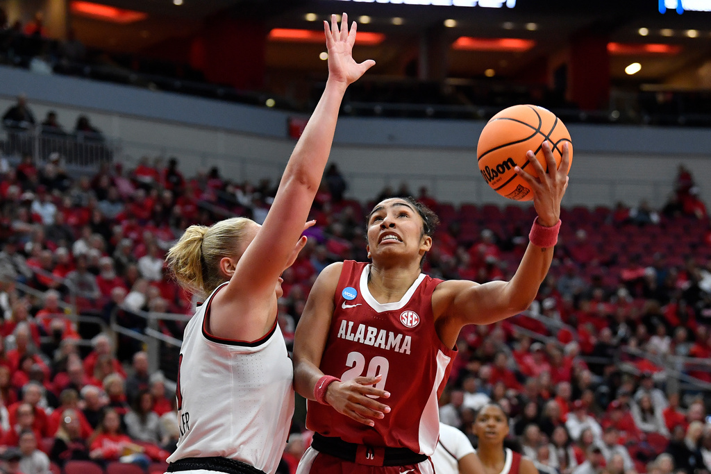 Alabama guard Diana Collins (20) shoots over Louisville forward Laura Ziegler (0) during the first half in the second round of the NCAA college basketball tournament, Monday, March 23, 2026 in Louisville, Ky. (AP Photo/Timothy D. Easley)